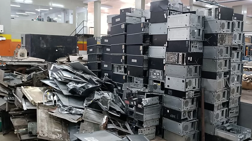 Stacks of discarded computers and IT equipment awaiting e-waste processing at Deshwal