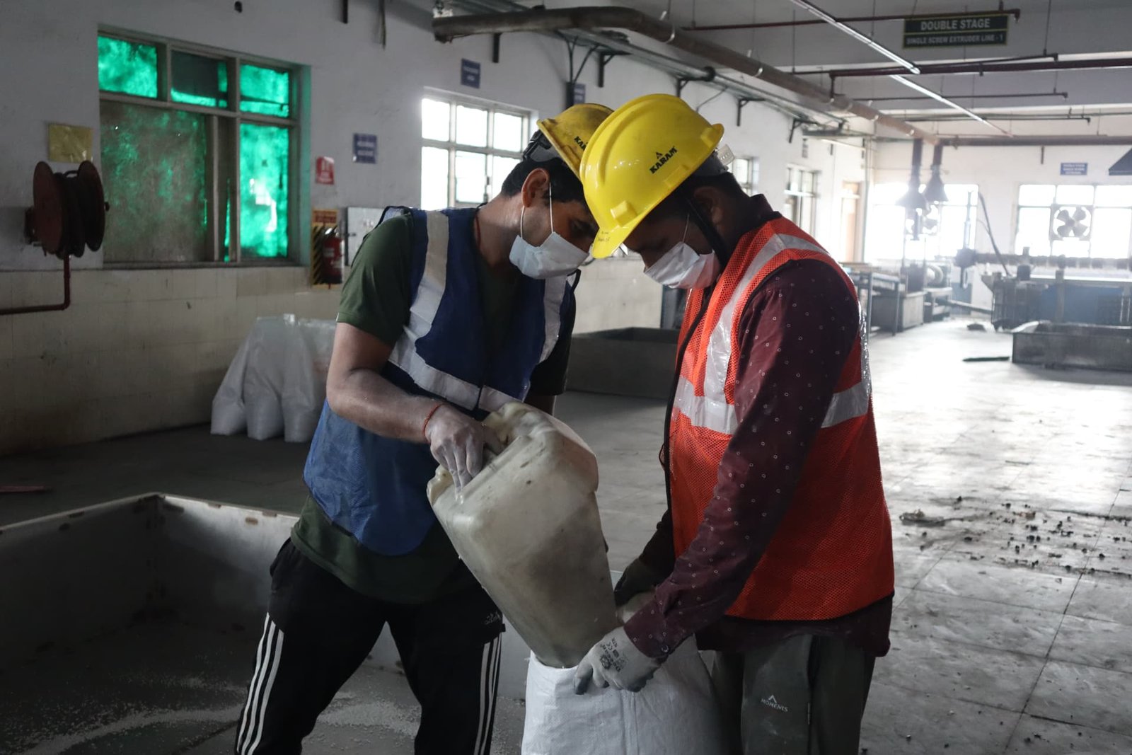 Deshwal workers handling material inside the processing plant